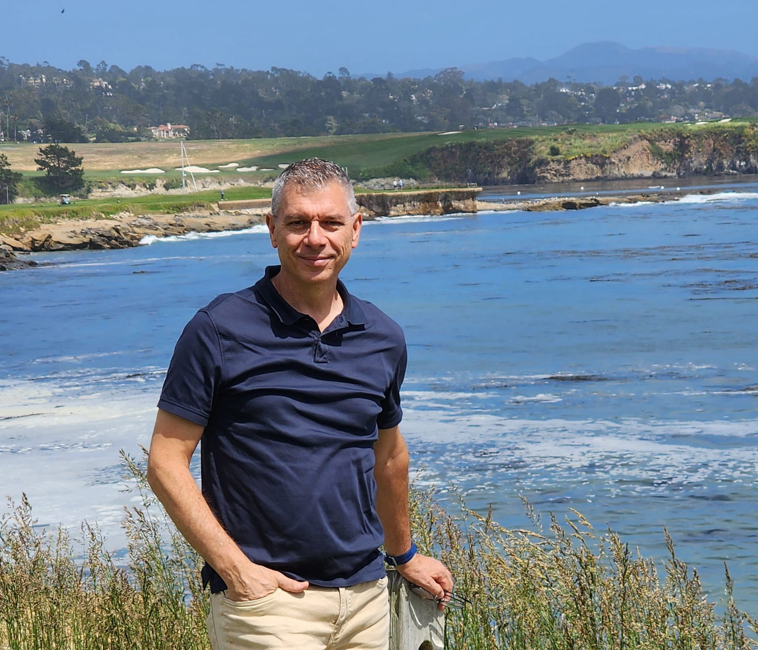 Ferrin Leadership's president Gino Ferrin standing in front of a deep blue body of water.
